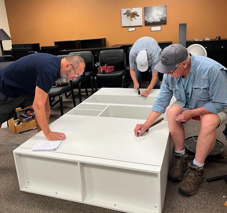 volunteers for Transitions putting together a cabinet
